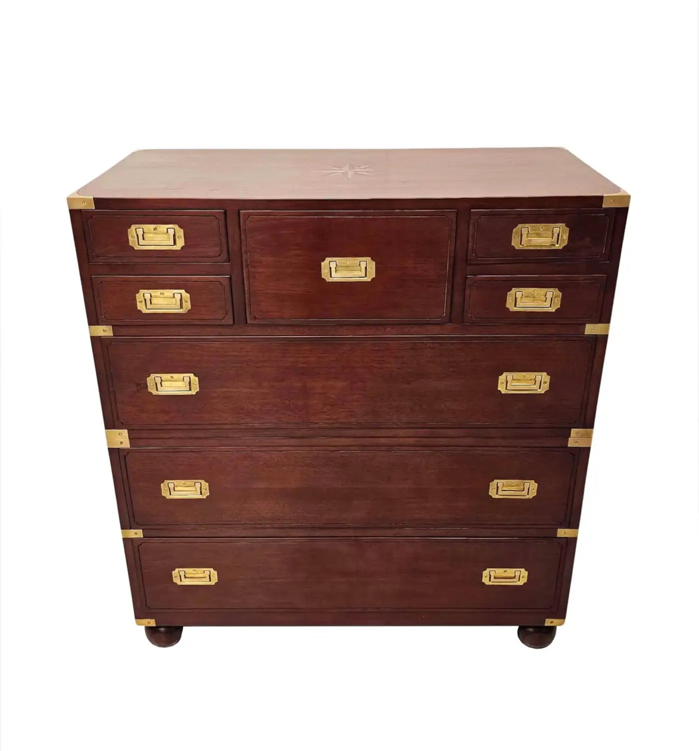Wooden dresser with brass accents on a white background
