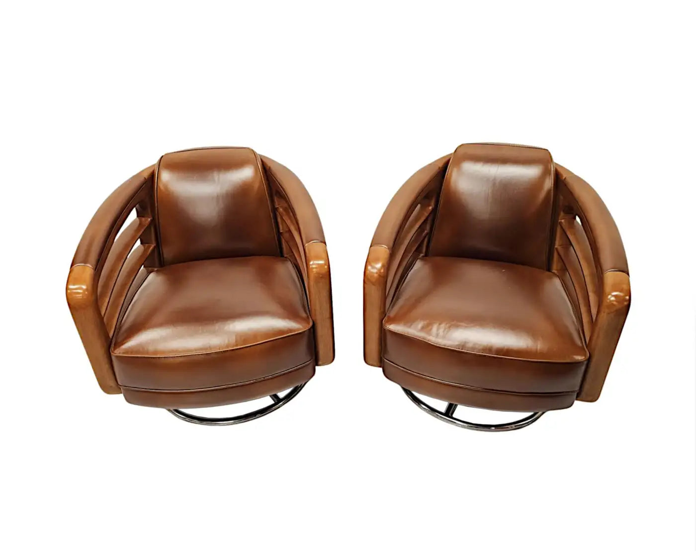 Pair of brown leather swivel chairs on a white background