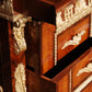 Close-up of a wooden cabinet with intricate carvings and gold accents