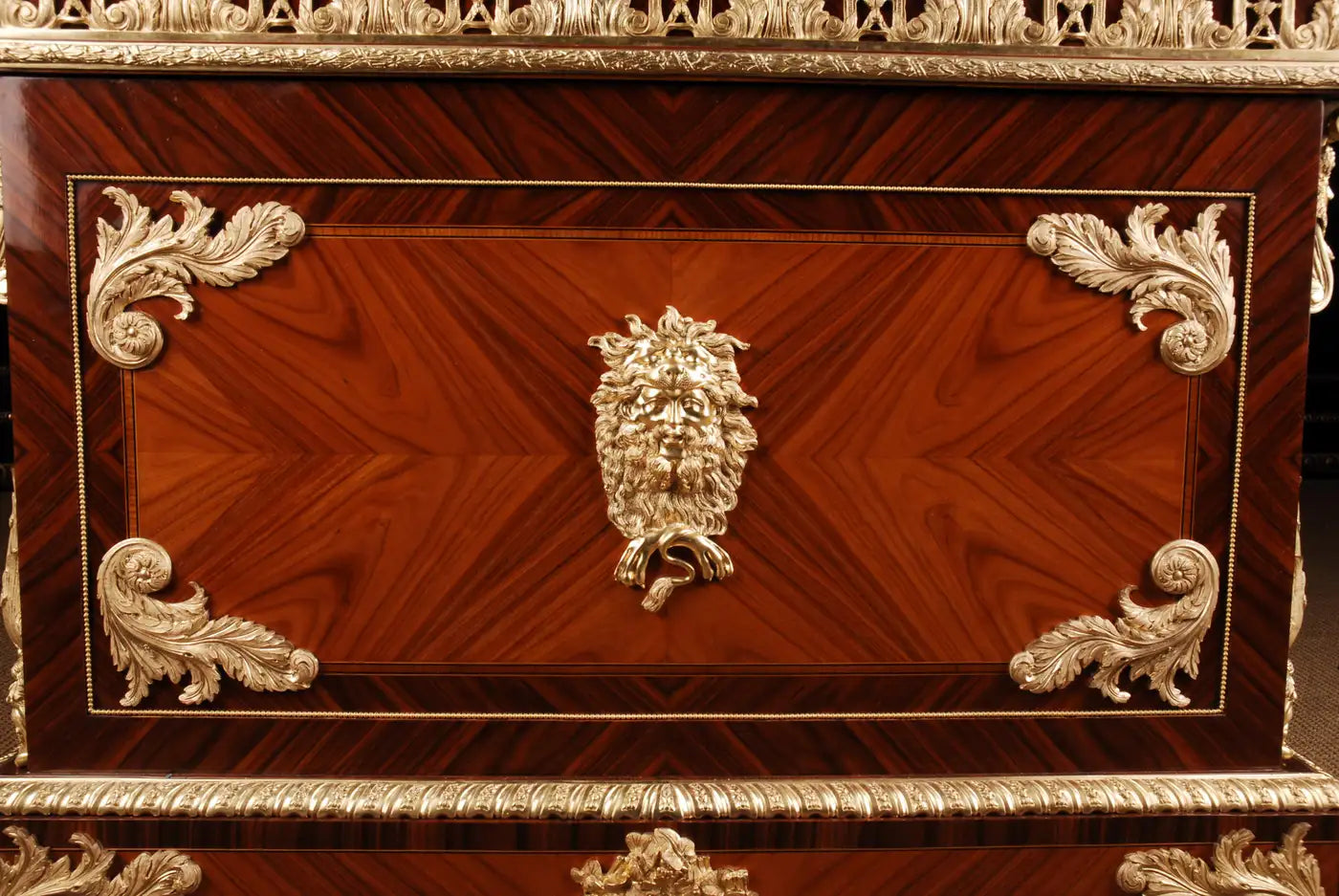Close-up of a wooden chest with intricate carvings and gold accents