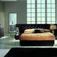 Modern bedroom with a large bed, nightstands, and decorative items.