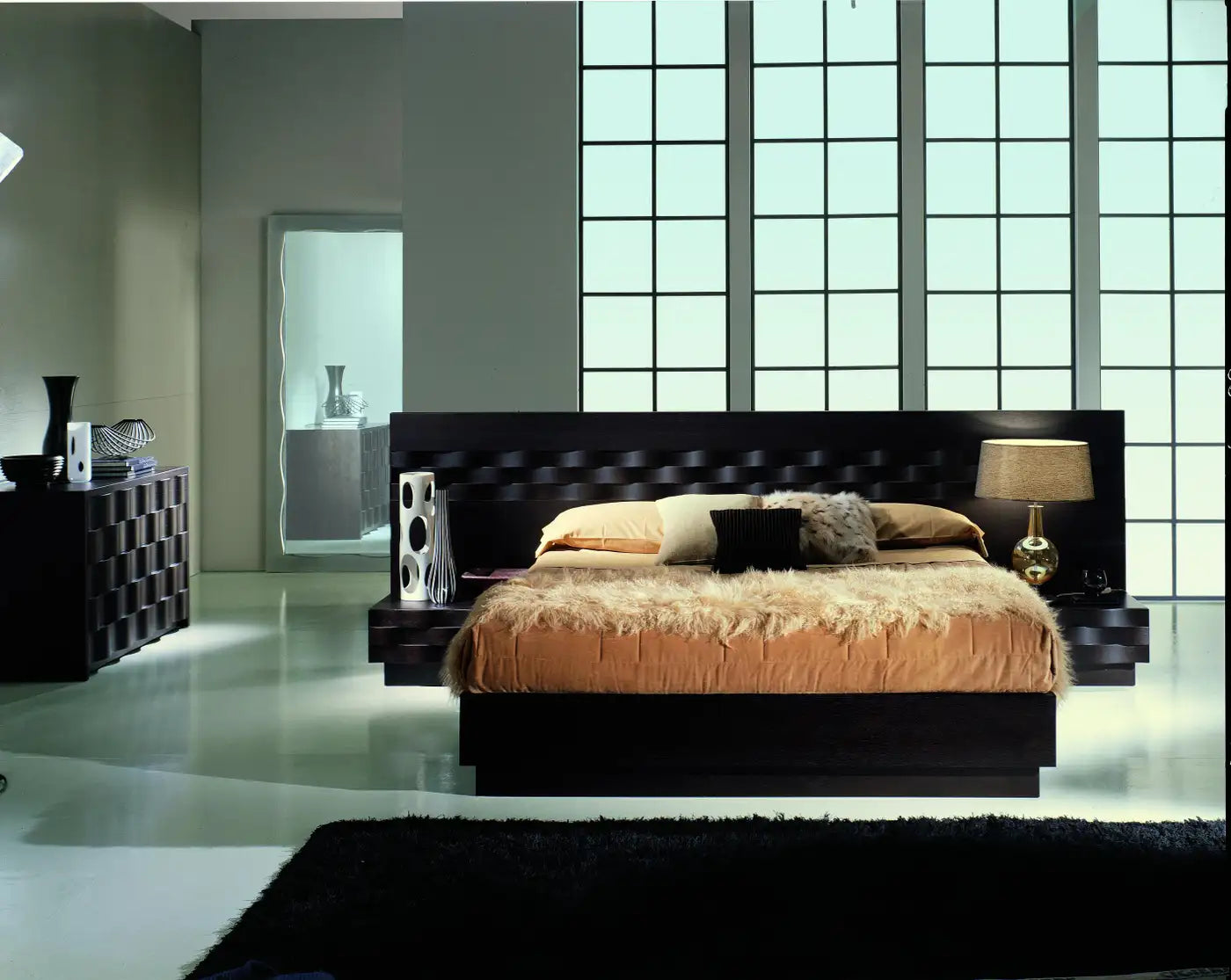 Modern bedroom with a large bed, nightstands, and decorative items.
