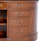 Close-up of a wooden desk with drawers and brass handles on a white background