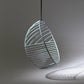 Modern pendant light with leaf-like design on a gray background