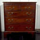 Wooden dresser with multiple drawers in a room setting