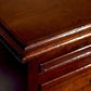 Close-up of a wooden drawer with a focus on the edge and handle.