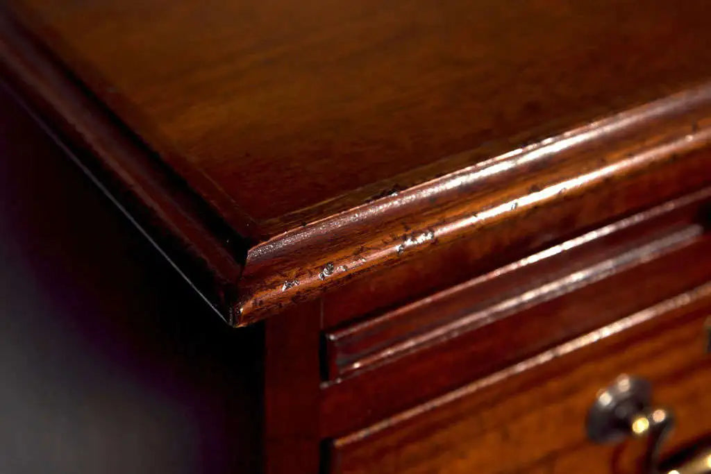 Close-up of a wooden drawer with a focus on the edge and handle.