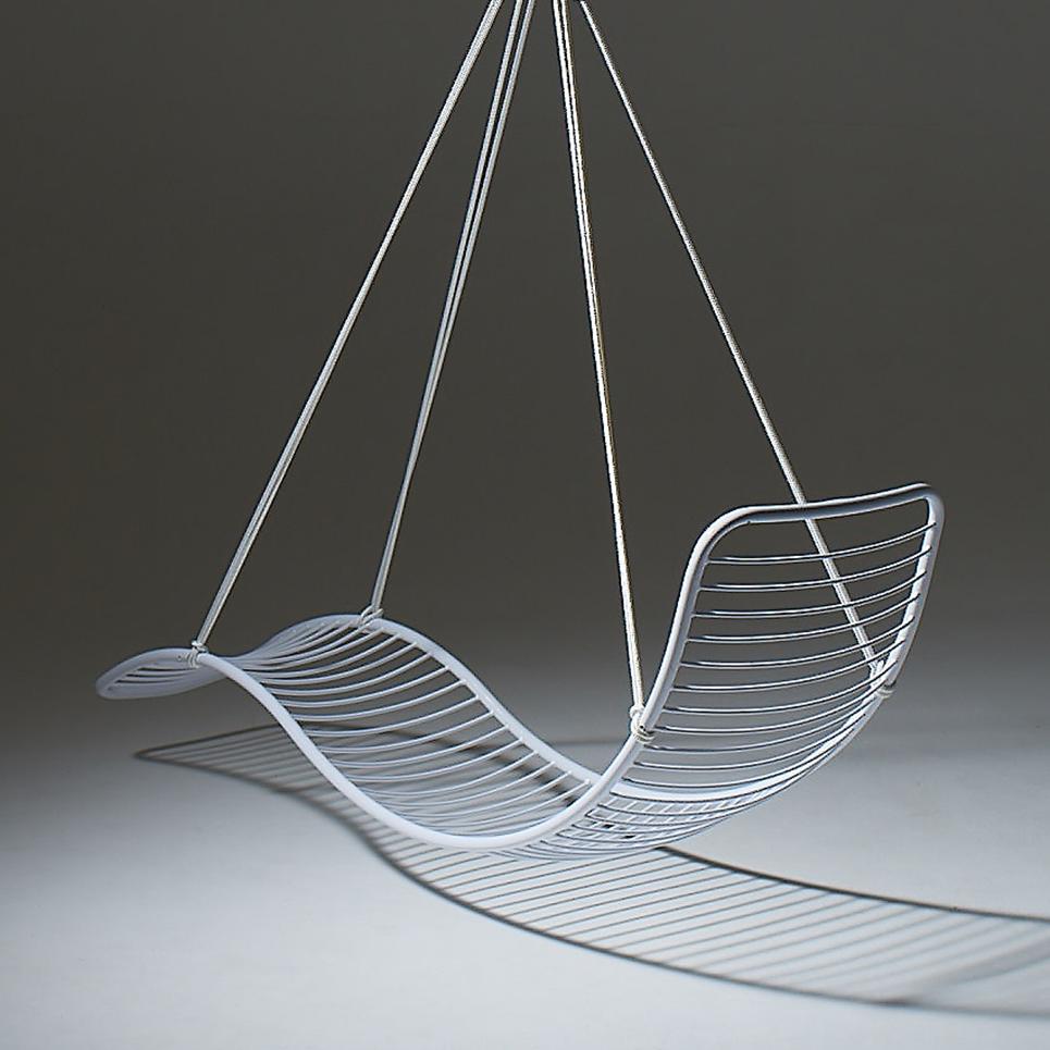 Modern wire chair with a minimalist design on a dark background