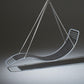 Modern hammock chair with gray cushion and metal frame on a dark background