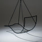 Black wire hanging chair on a dark background