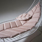 Pink cushioned lounge chair on a white background