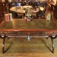 Wooden desk with leather surface in a room with wooden furniture