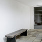 Modern bench against a white wall in an indoor setting