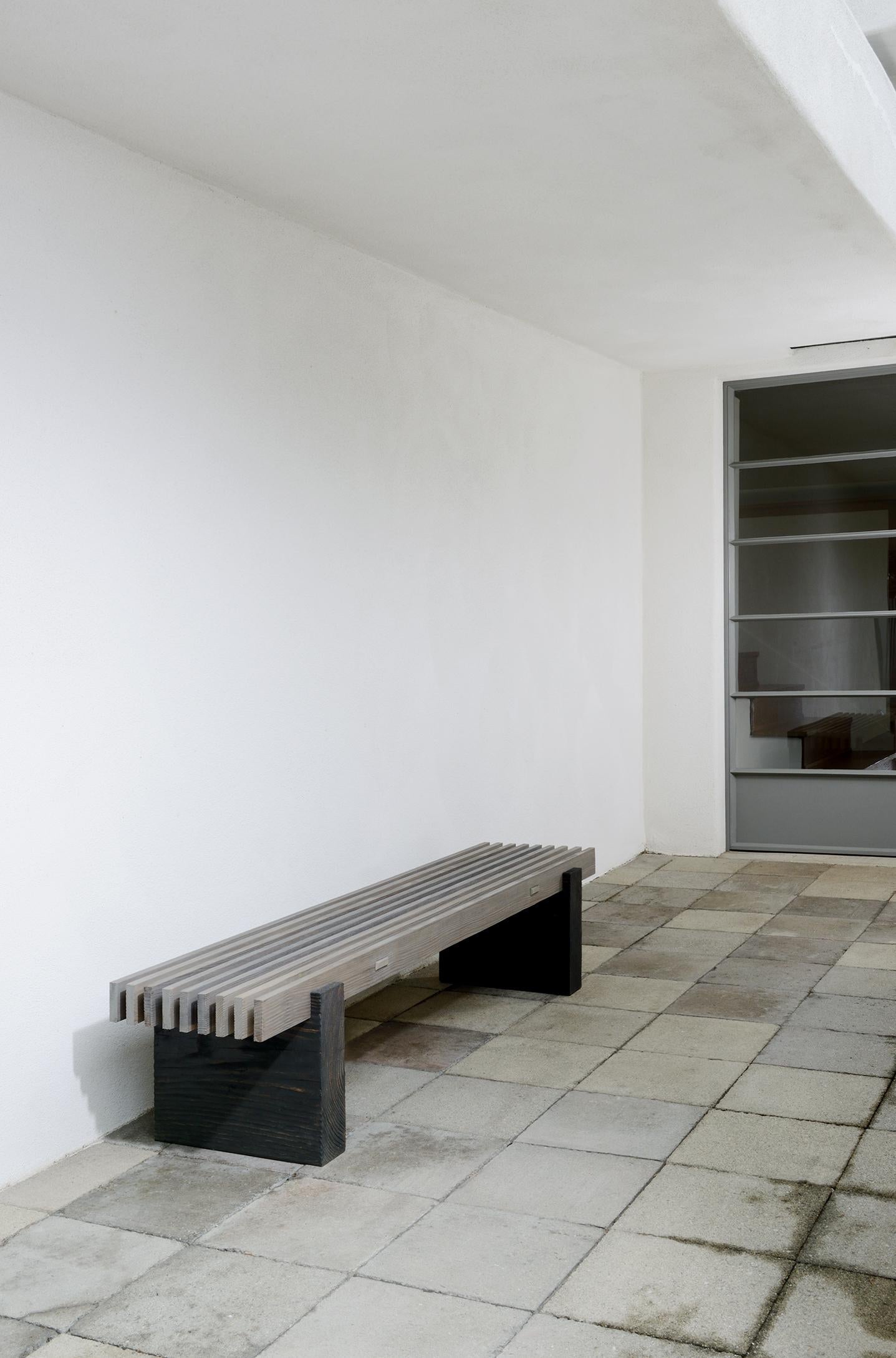 Modern bench against a white wall in an indoor setting