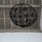 Black woven basket on a concrete step with a textured wall background