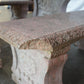 Stone bench with decorative carvings on a blurred background