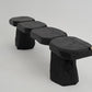 Black stone bench on a light gray background