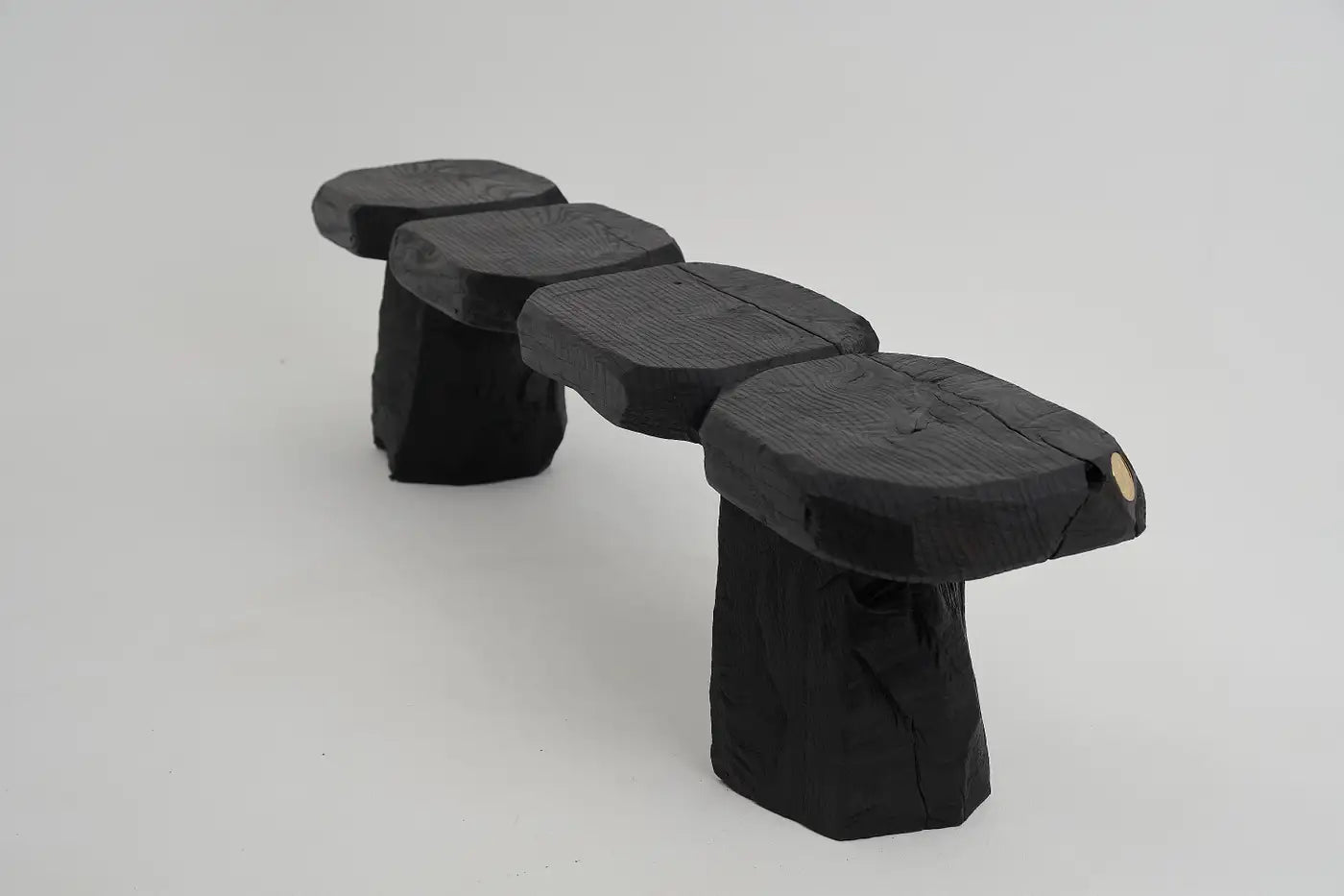 Black stone bench on a light gray background
