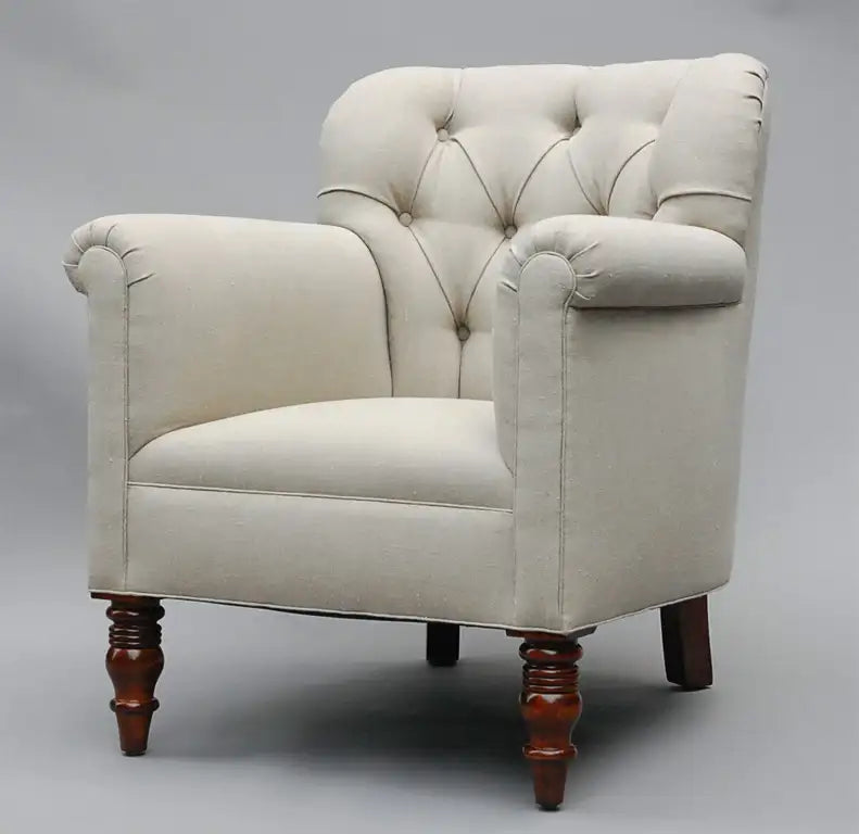 Beige armchair with wooden legs on a gray background