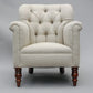Beige armchair with wooden legs on a gray background