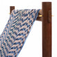 Textile with blue and beige pattern draped over a wooden rod on a white background