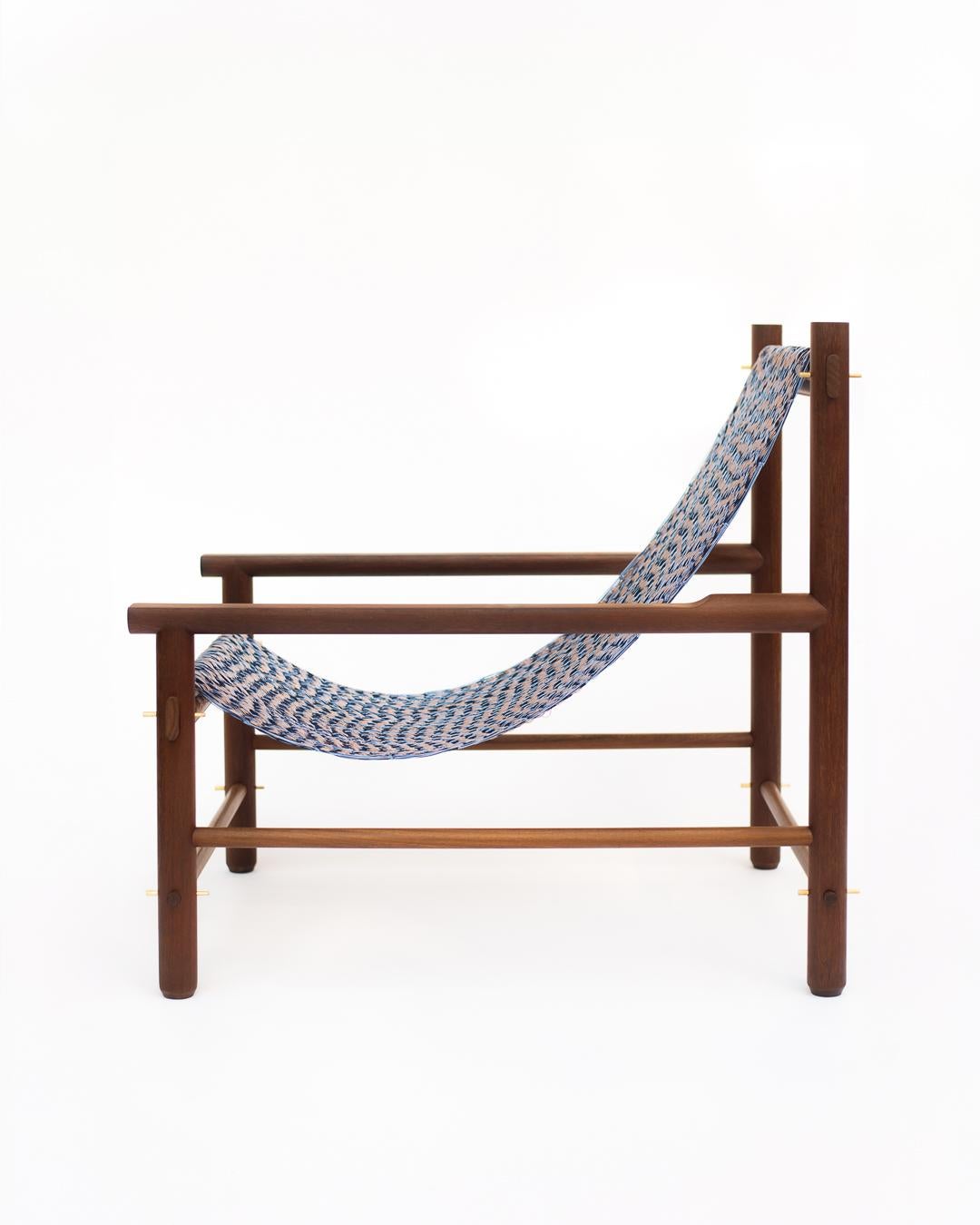 Wooden hammock stand with a blue and white striped hammock on a white background