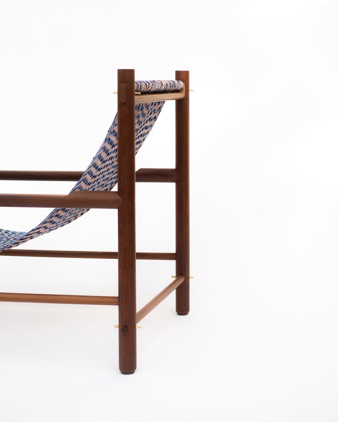 Wooden chair with a blue patterned seat on a white background