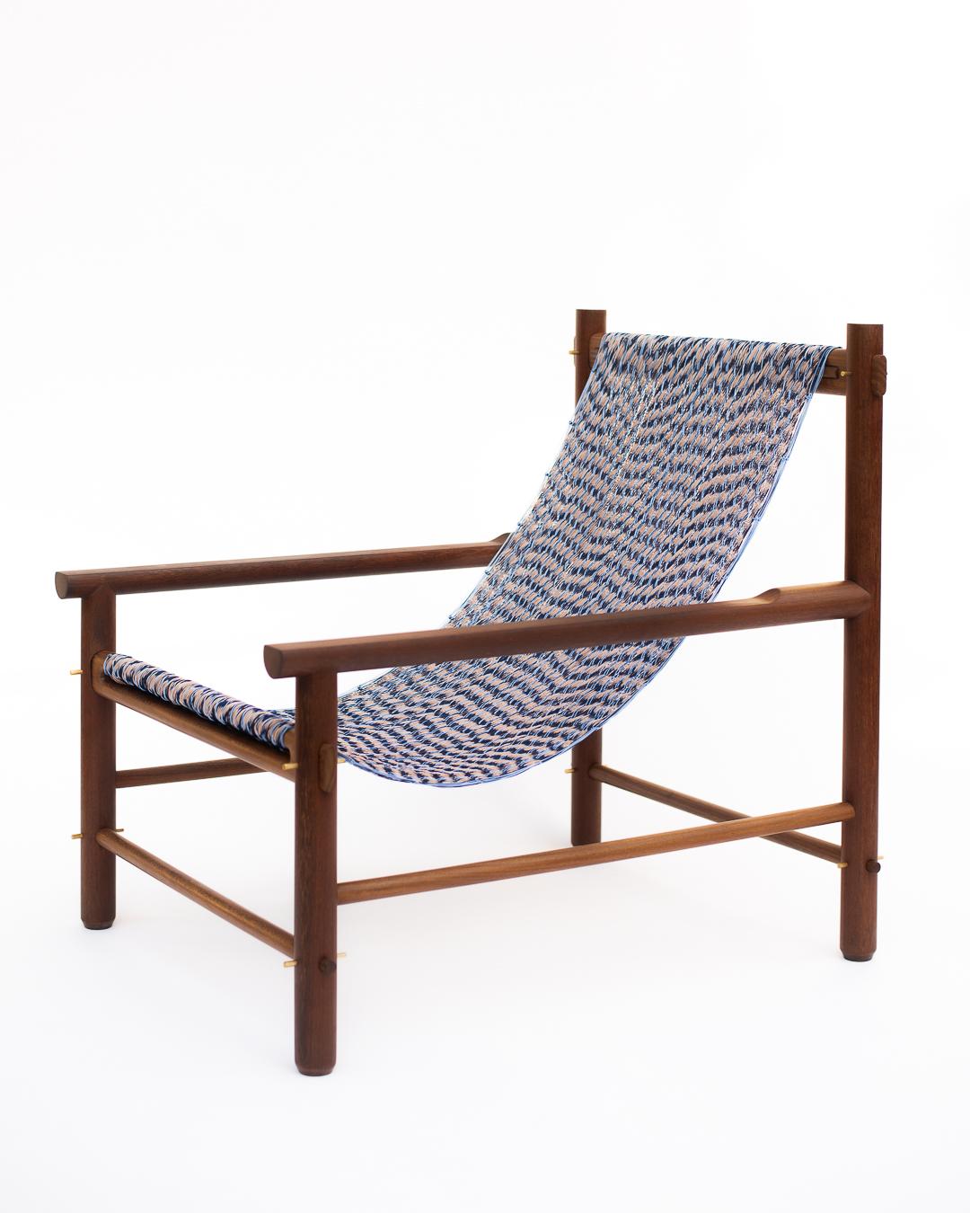 Wooden chair with a blue and white patterned fabric on a white background