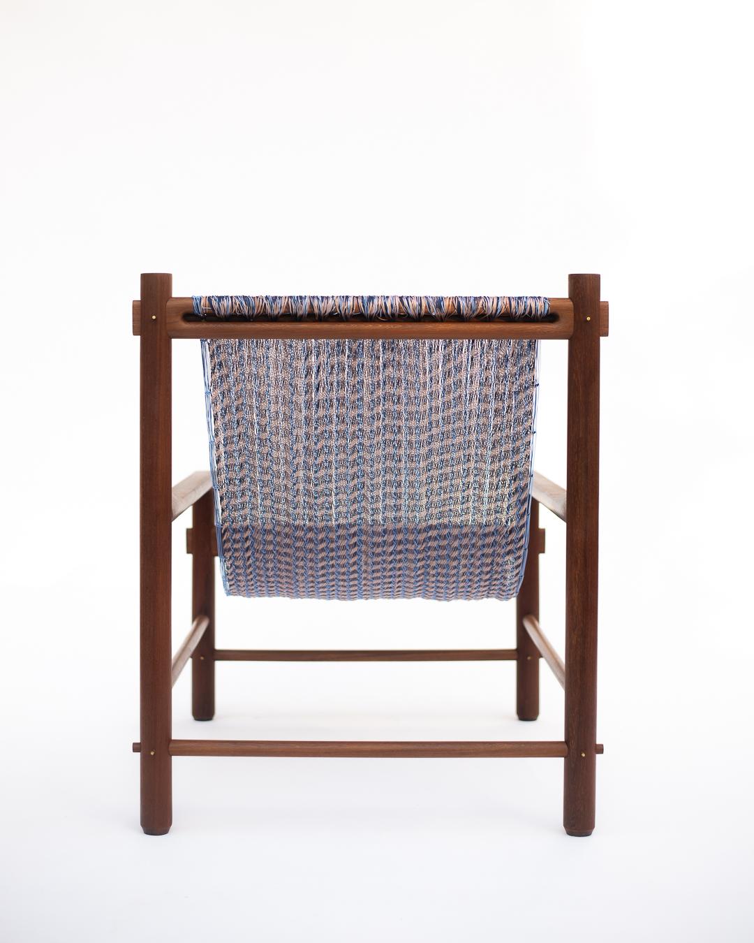 Chair with woven seat and wooden frame on a white background
