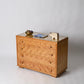 Wooden dresser with decorative items on a plain background