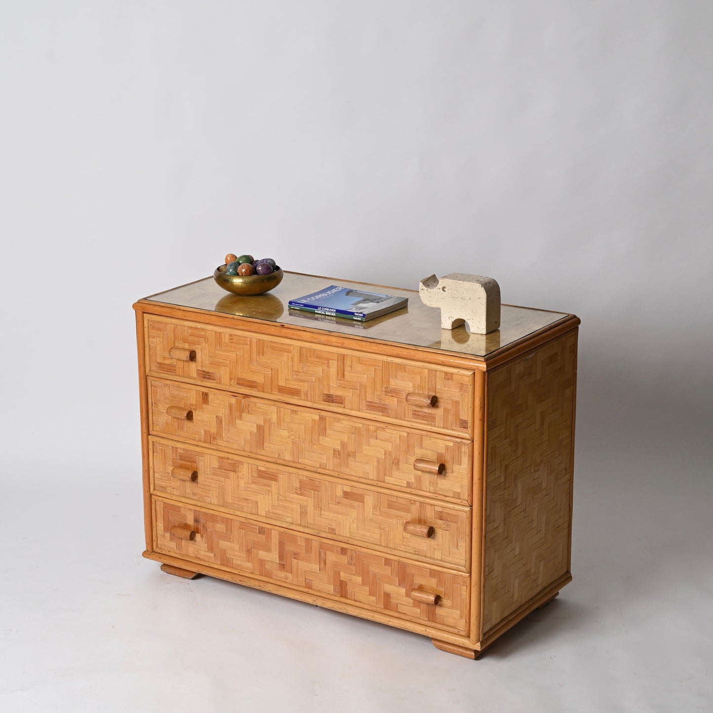 Wooden dresser with decorative items on a plain background