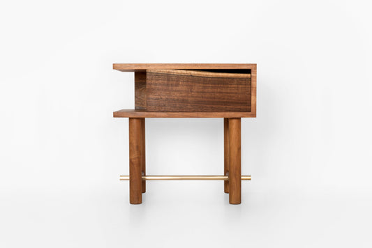 Wooden side table with a drawer on a white background