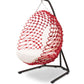 Red netted hanging chair with white cushion on a black stand against a white background