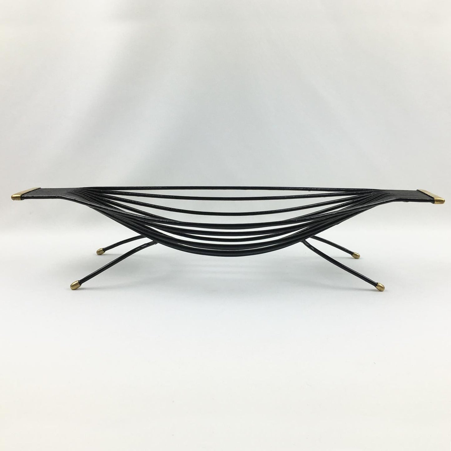 Black metal coffee table with gold accents on a white background