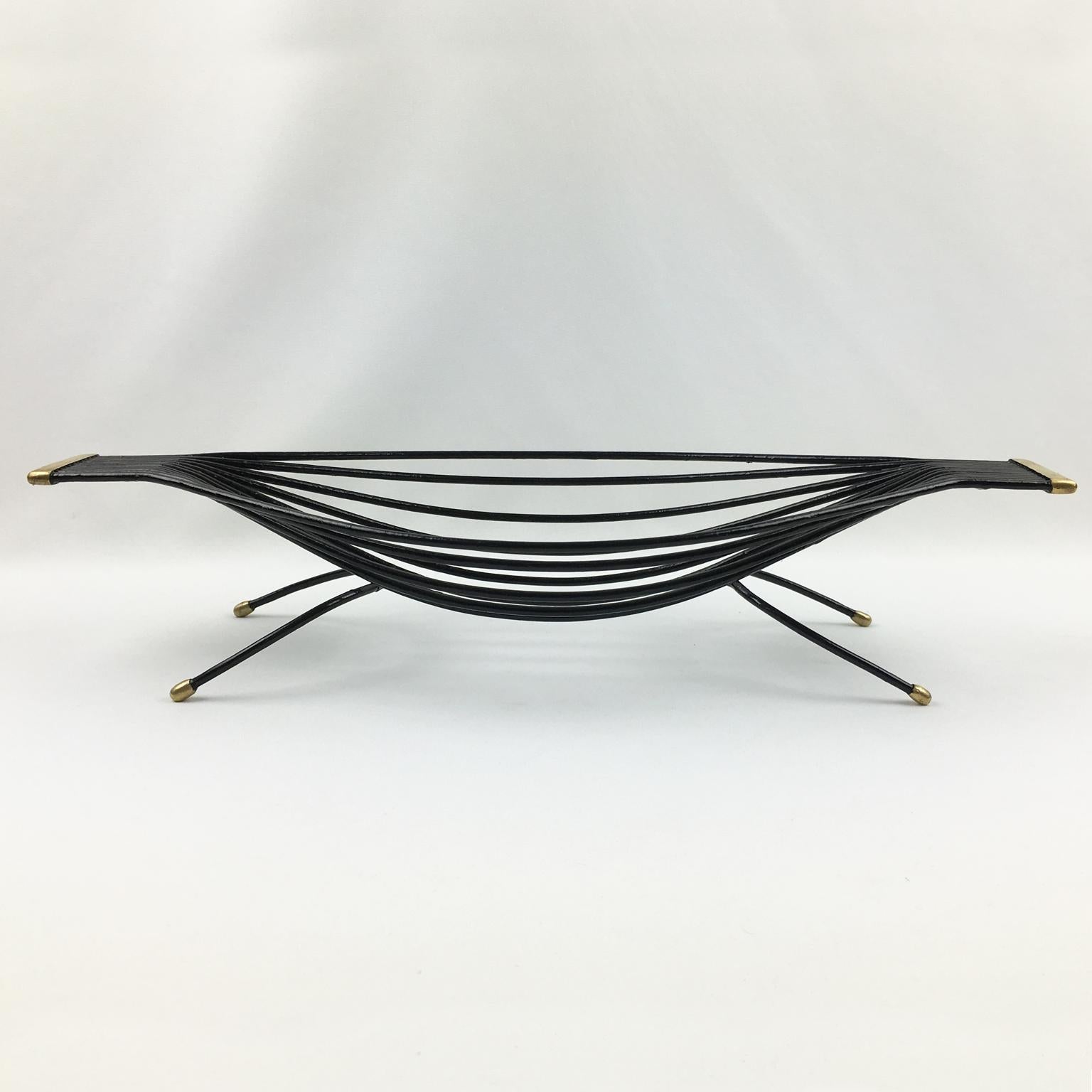 Black metal coffee table with gold accents on a white background