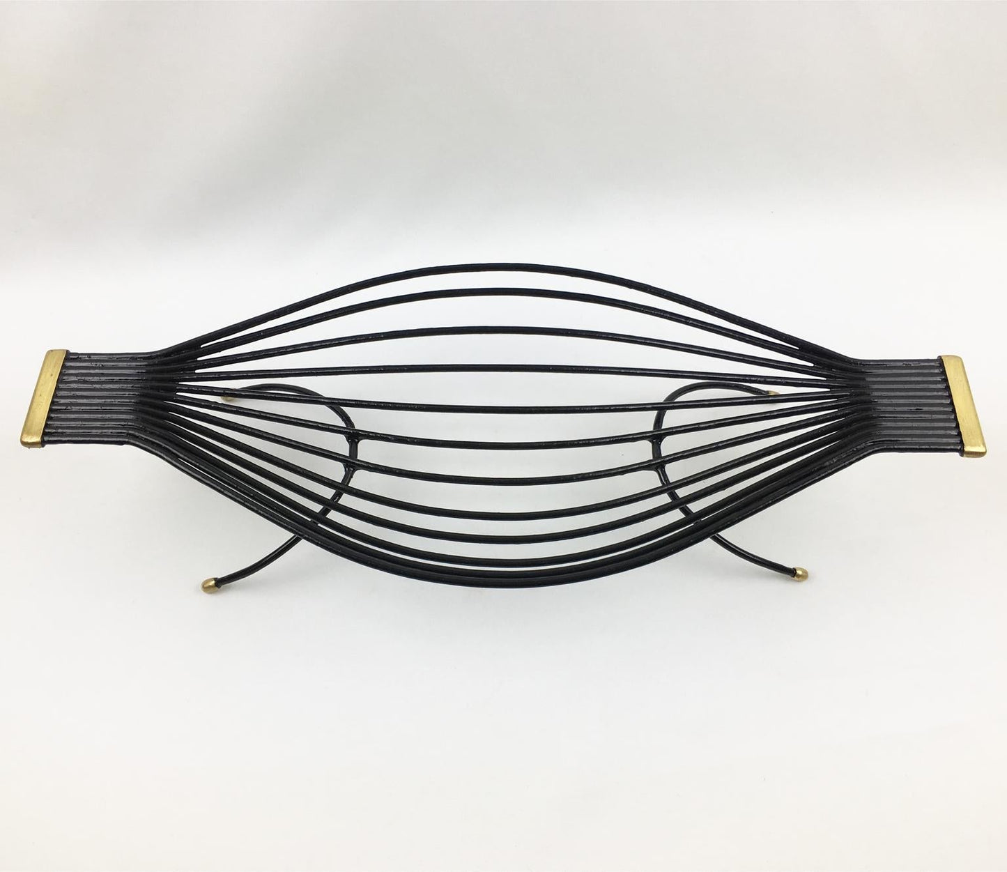 Black metal hairbrush with gold accents on a white background