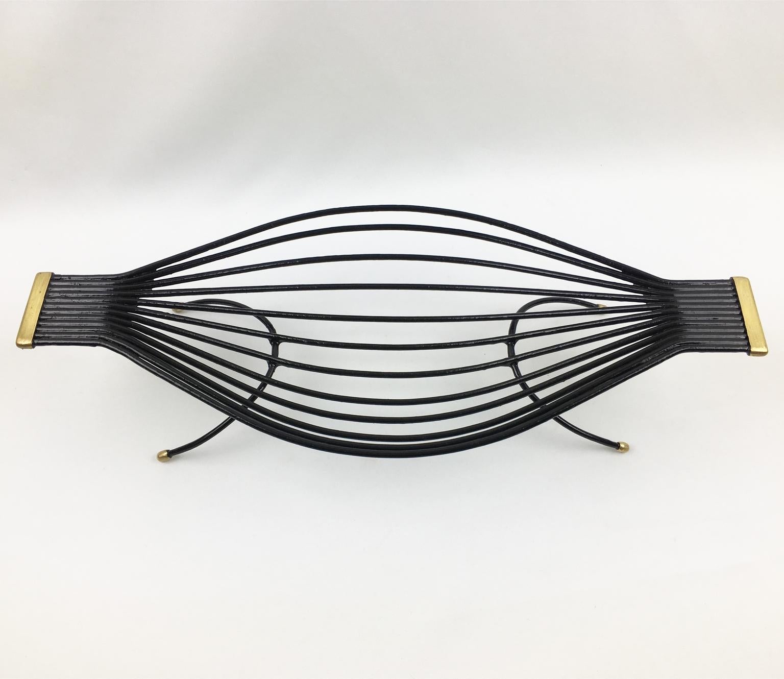 Black metal hairbrush with gold accents on a white background