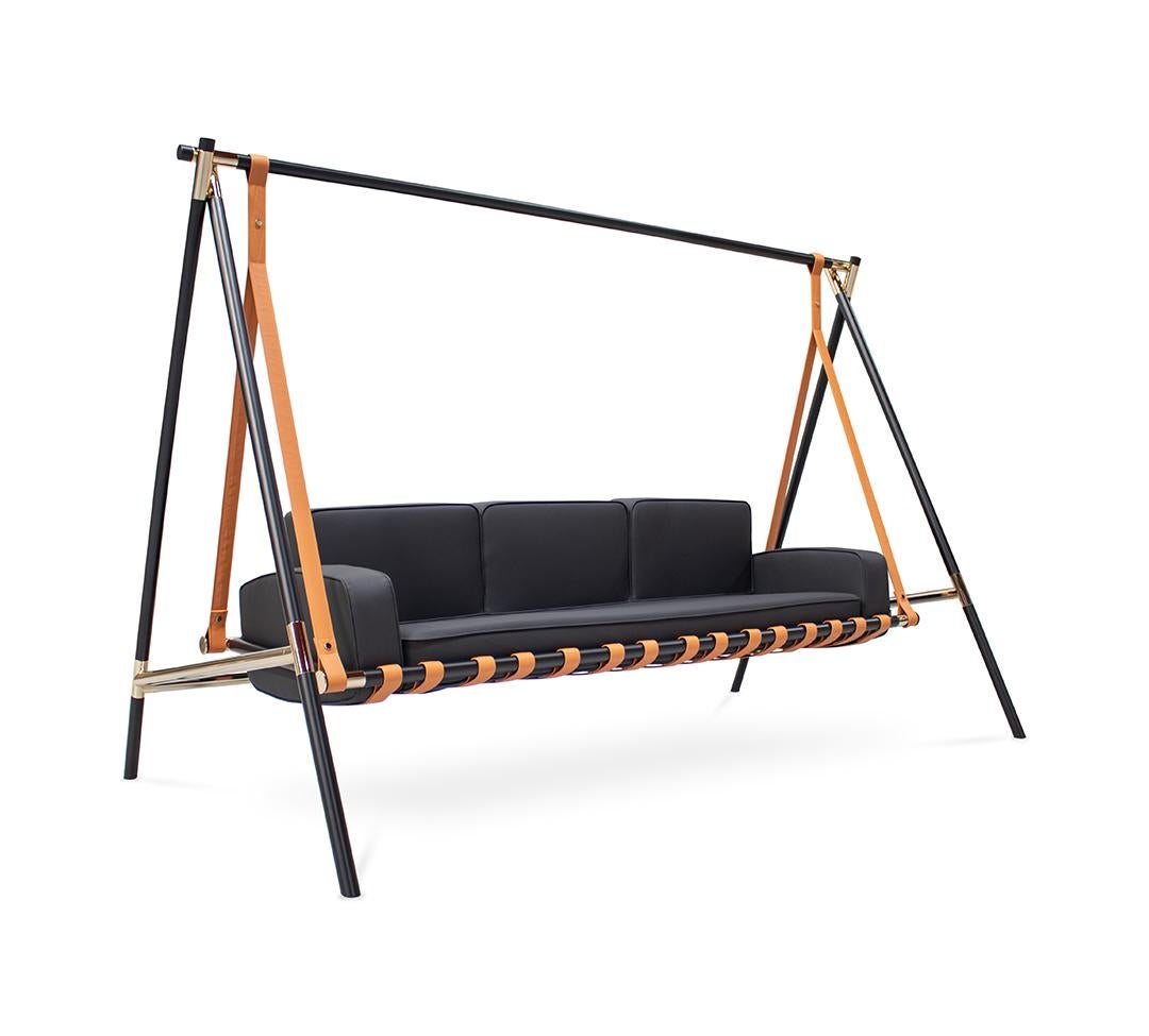 Modern swing with black cushions and orange straps on a white background
