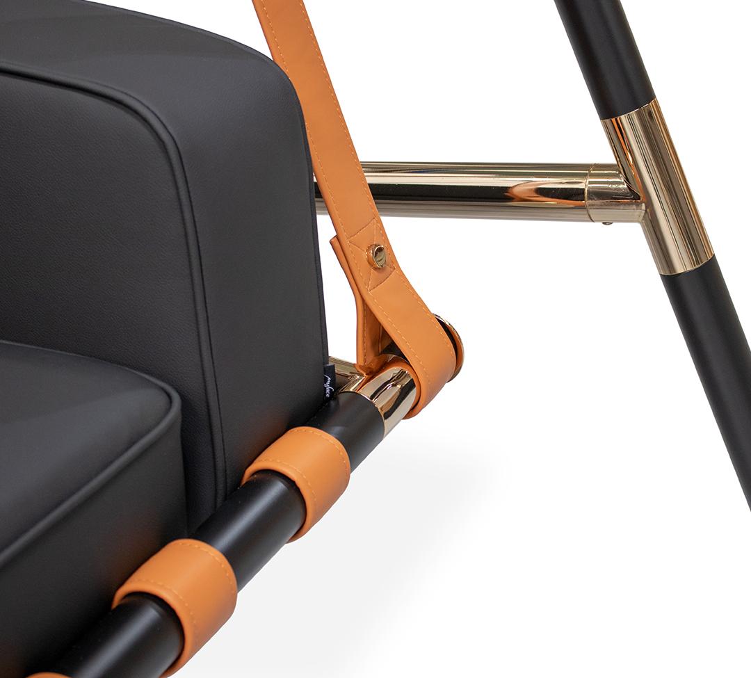 Black suitcase with orange handle and strap on a white background