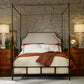 Bedroom with a four-poster bed, wooden nightstands, and stone wall.