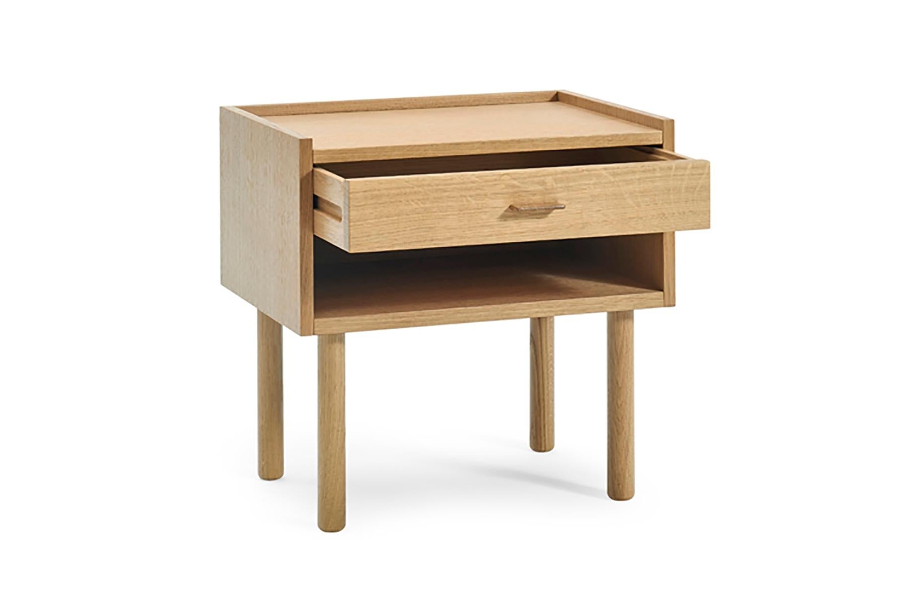 Wooden side table with a drawer on a white background