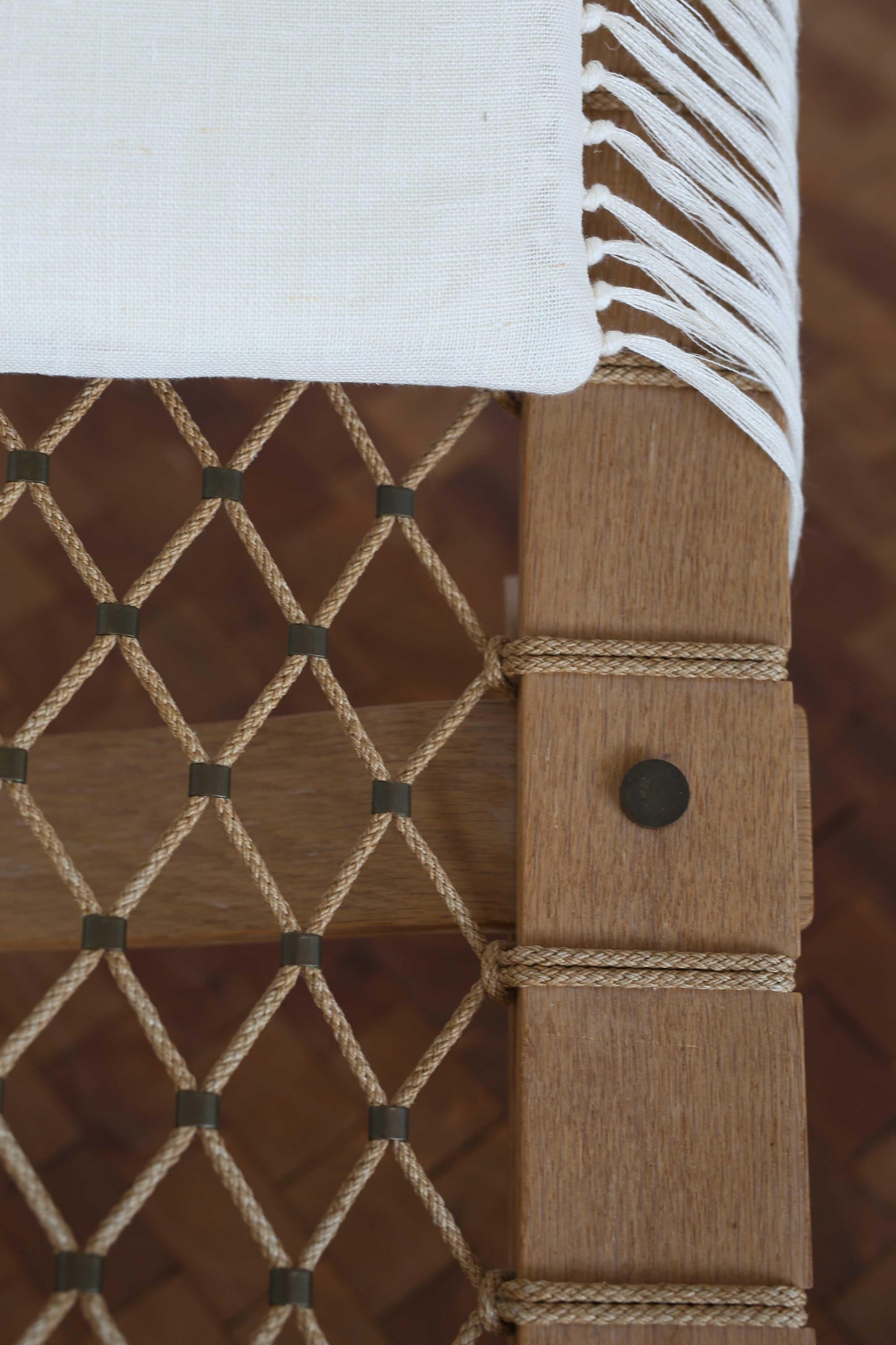 Close-up of a woven wooden chair with rope detailing