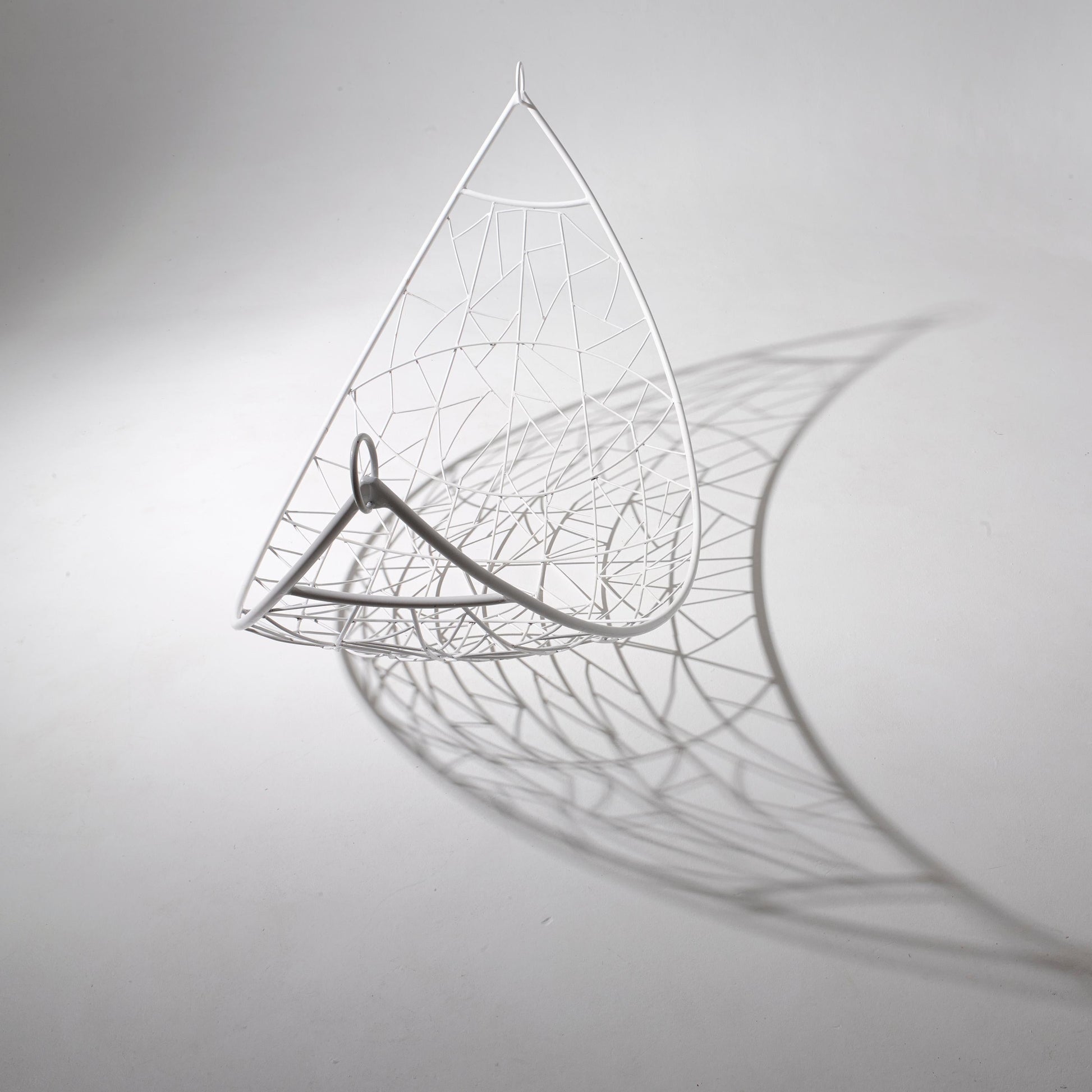 Decorative leaf sculpture with intricate patterns on a plain background
