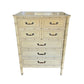White dresser with bamboo-style design and glass top on a white background