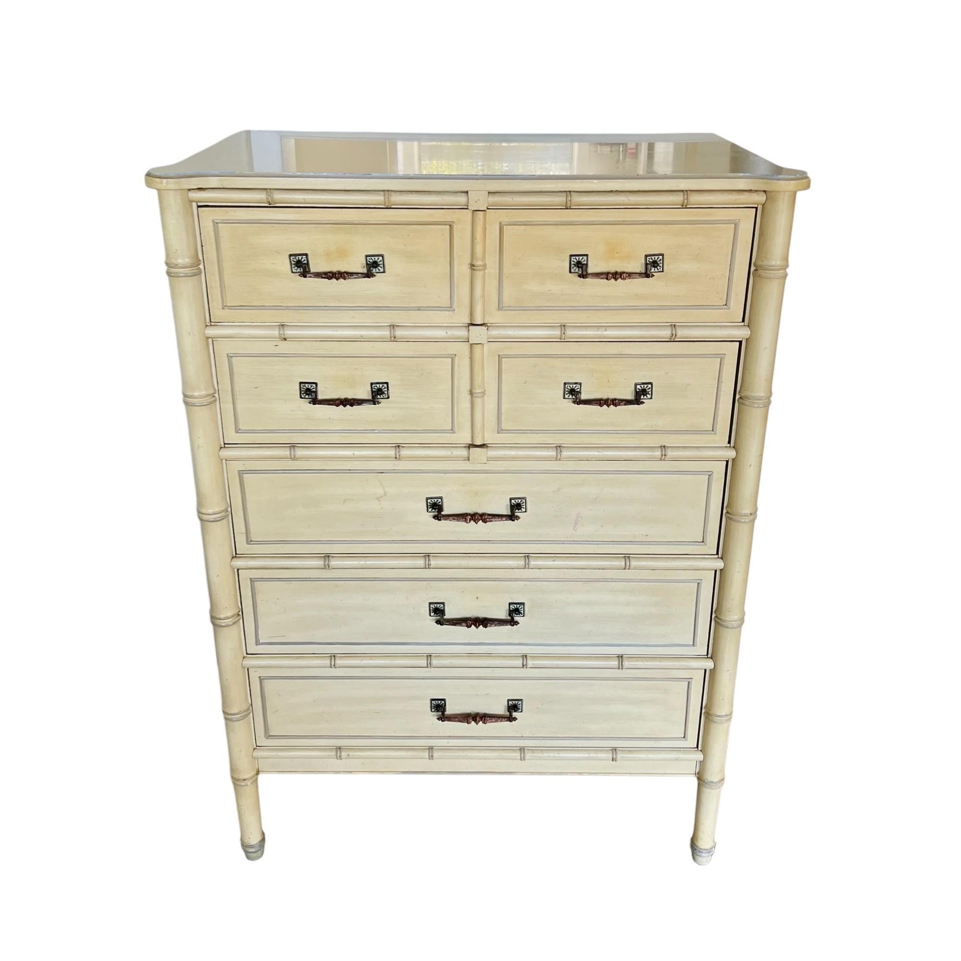 White dresser with bamboo-style design and glass top on a white background