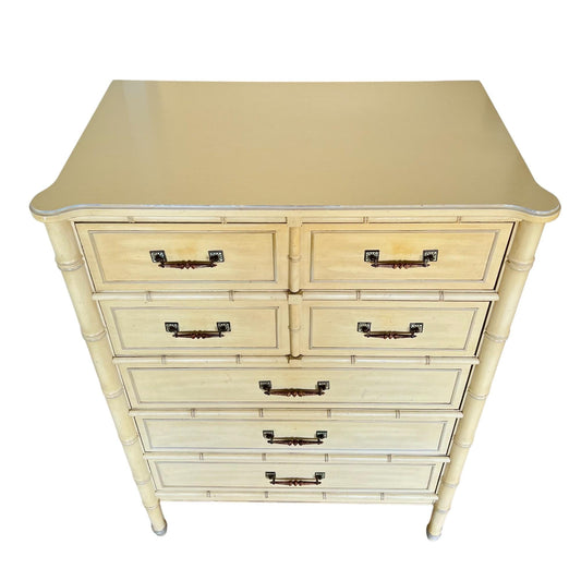 Beige dresser with multiple drawers on a white background