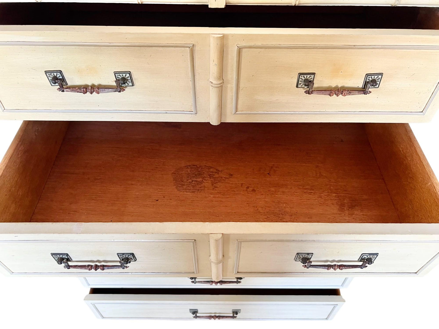 Open drawer of a white dresser with wooden interior