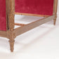 Decorative wooden armchair with red velvet upholstery on a white background