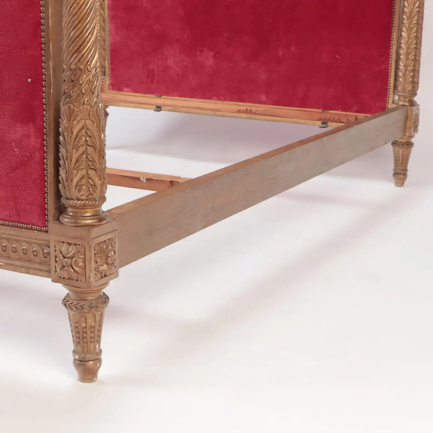 Decorative wooden armchair with red velvet upholstery on a white background