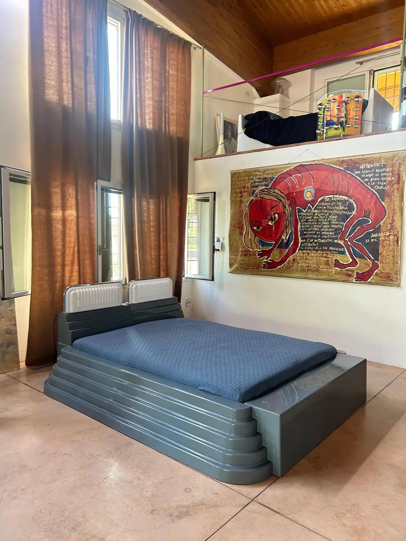 Modern bedroom with a unique bed design and colorful wall art.
